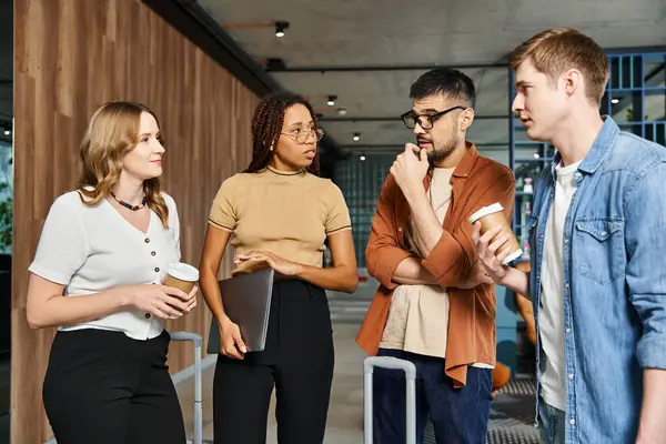 Multicultural colleagues in casual clothes stand in a circle, engaging in conversation and team bonding during a corporate trip. — Stock Photo