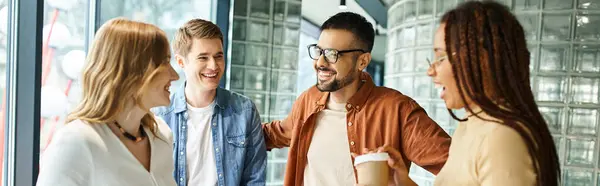 Multicultural colleagues standing together in a hotel lobby during a corporate trip, showcasing diversity and unity. — Stock Photo