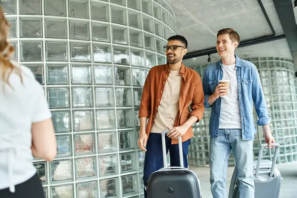 Businesspeople, walk together with luggage in a hotel during a corporate trip. — Stock Photo
