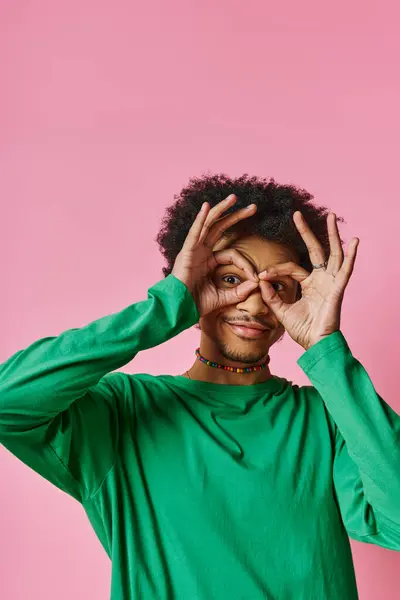 African american man with curly hair covers his eyes with hands. — Stock Photo