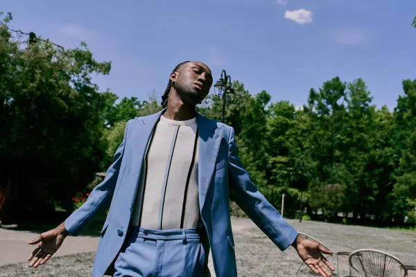 African American man in blue suit stands on the outside. — Stock Photo
