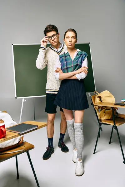 Elegant male and female students posing in front of a green board in college. — Stock Photo