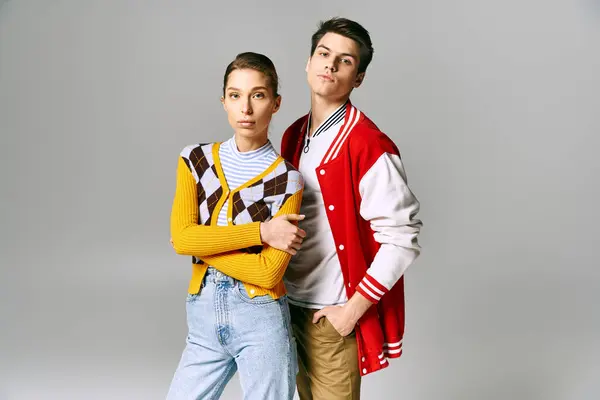 Young male and female students in casual attire posing coyly in a college classroom. — Stock Photo