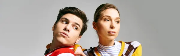 Attractive male and female students in casual attire standing next to each other in a college classroom. — Stock Photo