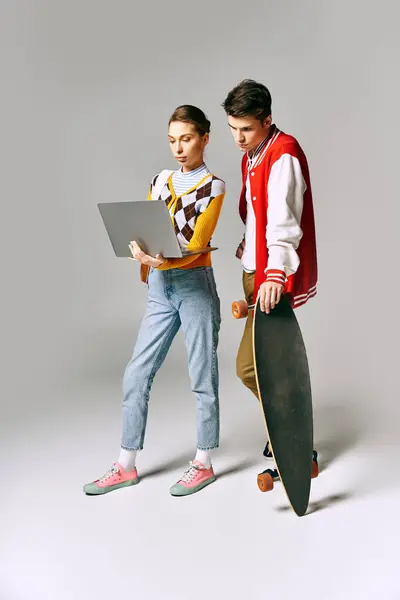 Young students with skateboard and laptop, exuding cool casual vibes in college setting. — Stock Photo