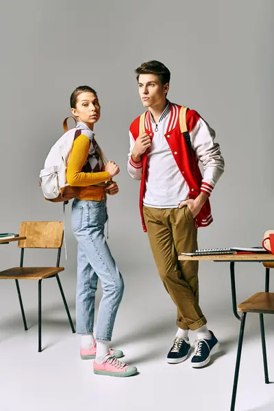 Two young individuals strike poses in a college classroom setting. — Stock Photo
