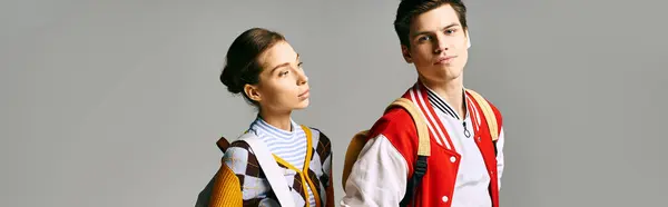 A stylish male and female students stand confidently in a college classroom. — Stock Photo