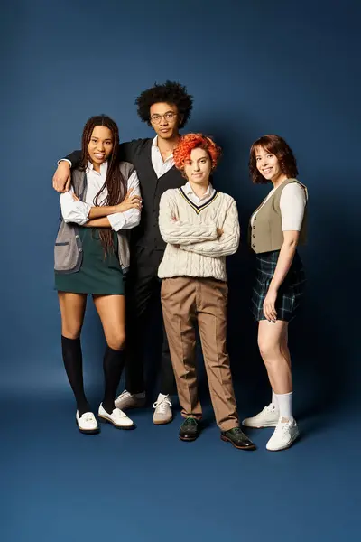 Multicultural friends, including a nonbinary person, stand together in stylish attire on a dark blue background. — Stock Photo