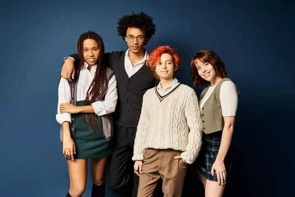 Multicultural friends, including a nonbinary person, stand together in stylish attire on a dark blue background. — Stock Photo