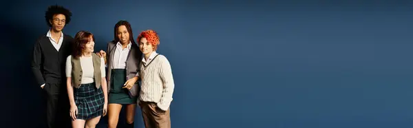 A diverse group of young multicultural friends, stand together in stylish attire on a dark blue background. — Stock Photo
