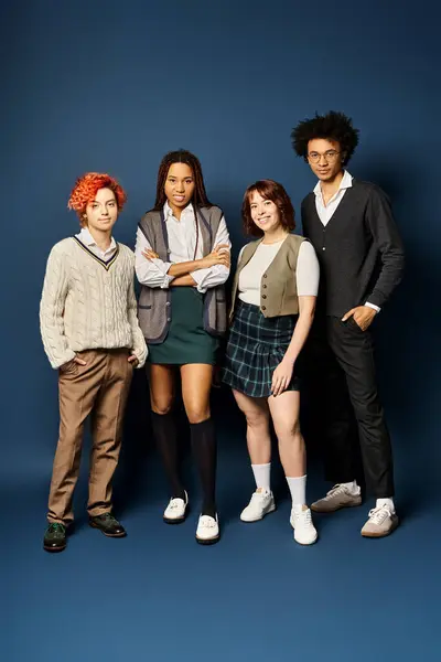 Eine bunte Gruppe junger Freunde, vereint in stylischer Kleidung vor dunkelblauem Hintergrund. — Stockfoto