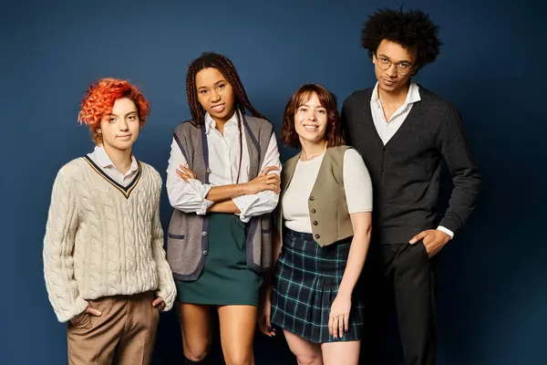 A group of young multicultural friends, standing together in stylish attire on a dark blue background. — Stock Photo