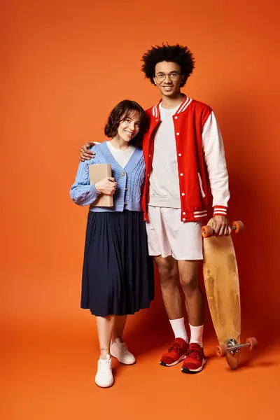 Man and a woman, both young and multicultural, stand side by side in stylish attire in a studio setting. — Stock Photo