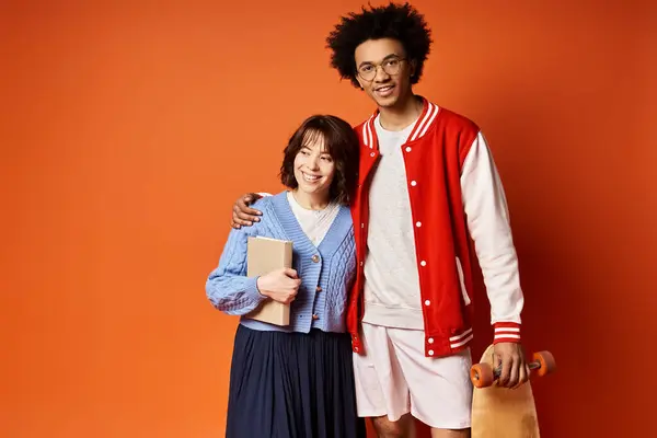 A young multicultural duo, standing confidently together in stylish attire in a studio setting. — Stock Photo