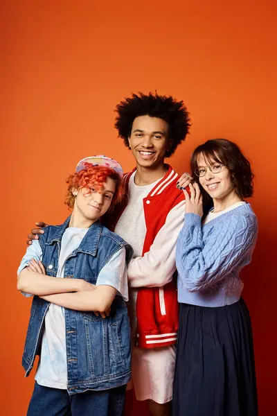 A group of young multicultural friends, including a nonbinary person, standing together in stylish attire in a studio setting. — Stock Photo