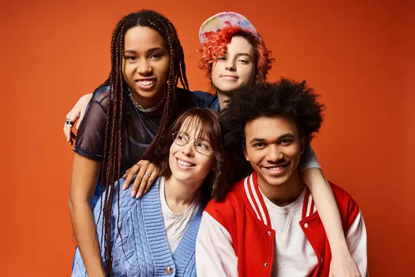 Young interracial friends, including a nonbinary person, standing together in stylish attire in a studio setting. — Stock Photo