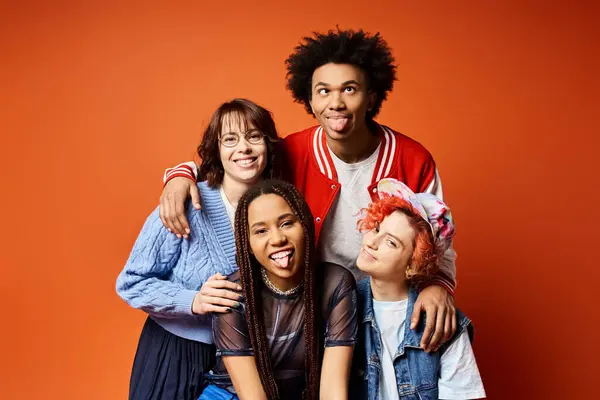 A diverse group of young friends, including a nonbinary individual, standing together in stylish attire in a studio setting. — Stock Photo