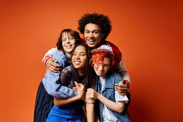 Multicultural young friends, including a nonbinary individual, dressed stylishly, standing together and posing for a picture. — Stock Photo
