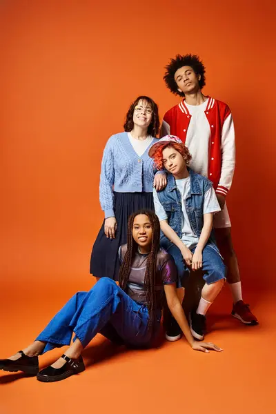 A group of young interracial friends, pose together in stylish attire in a studio setting. — Stock Photo