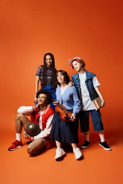 A diverse group of friends, including a nonbinary person, stand together in stylish attire, posing for a picture in a studio setting. — Stock Photo
