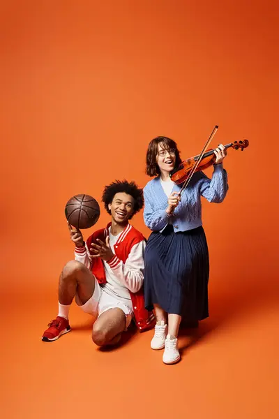 Young multicultural friends pose with a basketball and a violin in a stylish studio setting. — Stock Photo