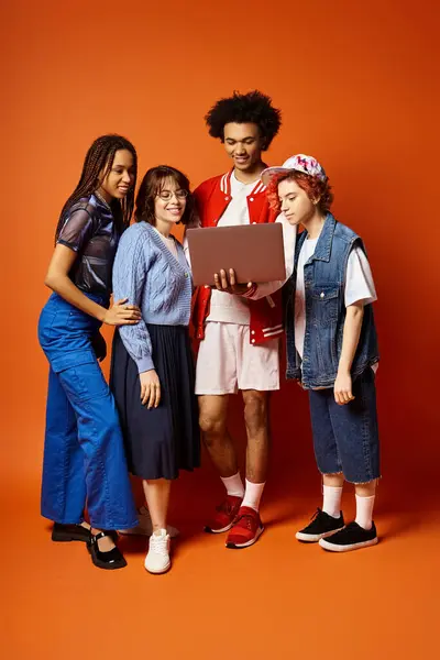 Diverse group of young friends, including a nonbinary person, standing stylishly together in a studio setting. — Stock Photo