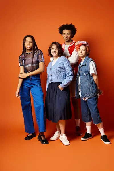 Un gruppo di giovani amici multiculturali, tra cui una persona non binaria, in piedi insieme in abiti eleganti in un ambiente di studio. — Foto stock