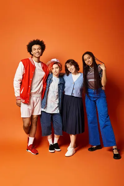 A diverse group of young friends, standing together in stylish attire in a studio setting. — Stock Photo