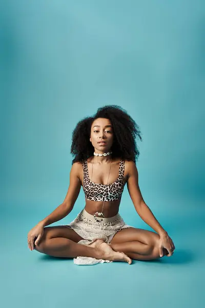 Young woman meditating in swimsuit on blue background. — Stock Photo