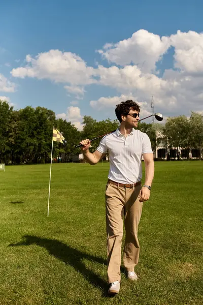 Holding a golf club — Stock Photo