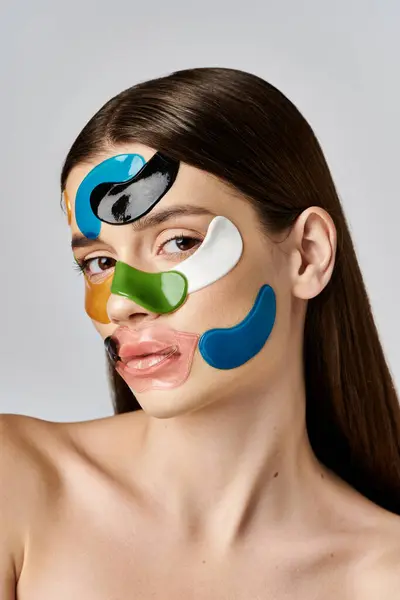 A beautiful young woman with eye patches on her face, adding a touch of fun and playfulness to her look. — Stock Photo