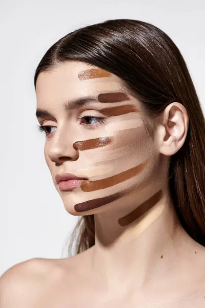 Beautiful young woman adorned with layers of foundation, showcasing intricate makeup artistry. — Stock Photo