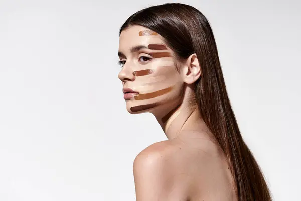 Tasteful young woman adorned with layers of foundation, showcasing intricate makeup artistry. — Stock Photo