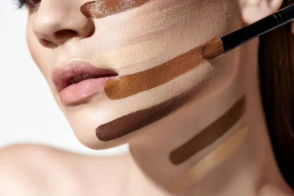 Elegant young woman adorned with layers of foundation, showcasing intricate makeup artistry. — Stock Photo