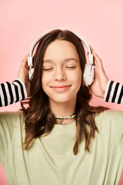 A stylish teenage girl with vibrant attire wearing headphones, enjoying music. — Foto stock