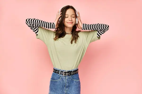 A stylish teenage girl in vibrant attire poses with hands on ears, expressing a sense of overwhelm or a need for quiet. — Stock Photo