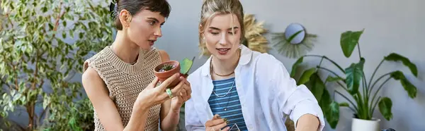 A loving, tender lesbian couple spending time at an art studio, standing next to each other. — Stock Photo