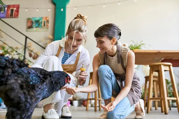 Lesbian couple pampering their furry companion on the studio floor. — Stock Photo