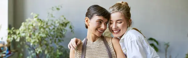A loving lesbian couple shares a tender moment in an art studio. — Stock Photo