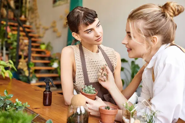 Two women, a loving lesbian couple, engage in a tender conversation in an art studio. — Stock Photo