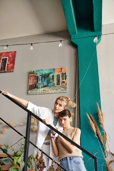 Lesbian couple in loving embrace on unique staircase. — Stock Photo