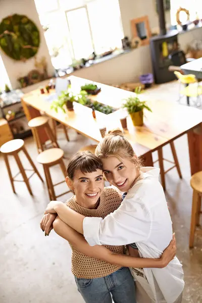 Lesbian couple, two women, bond while cooking in an artful space. — Stock Photo