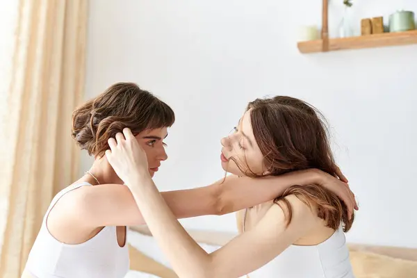 Two women in a bedroom, embracing each other warmly. — Stock Photo