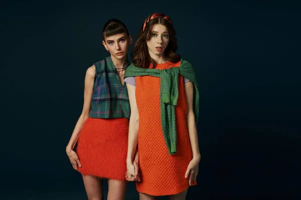 A beautiful lesbian couple stands side by side in comfy attire, showcasing their strong bond. — Stock Photo