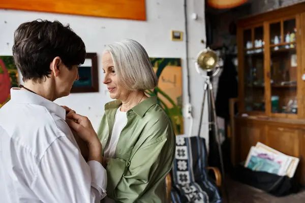 A mature lesbian couple hugging and looking at each other. — Stock Photo