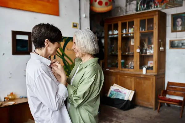 A mature woman looking at her partner in an art studio. — Stock Photo