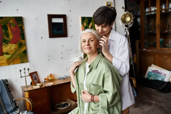 A mature lesbian couple posing together in art studio. — Stock Photo