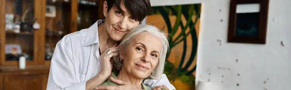 One woman tenderly holds her partner in his arms. — Stock Photo