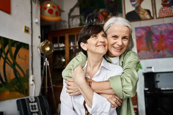 Two women share a heartfelt hug in a cozy setting. — Stock Photo