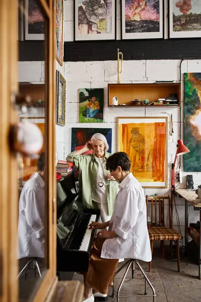 Mature lesbian couple exploring art studio together. — Stock Photo
